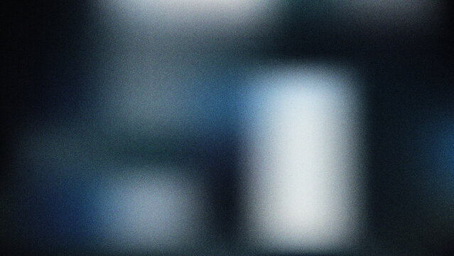 Abstract blurred dark blue and grey background with soft light effects and grainy texture offering a mysterious atmosphere