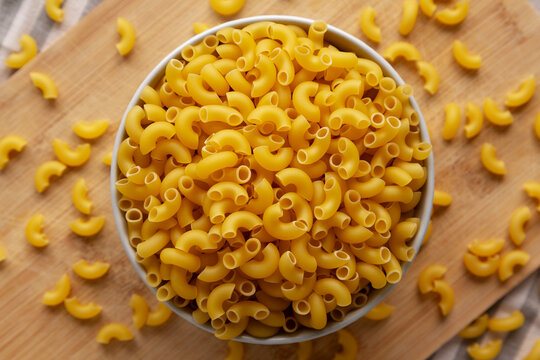Dry Organic Elbow Macaroni Pasta in a Bowl, top view.