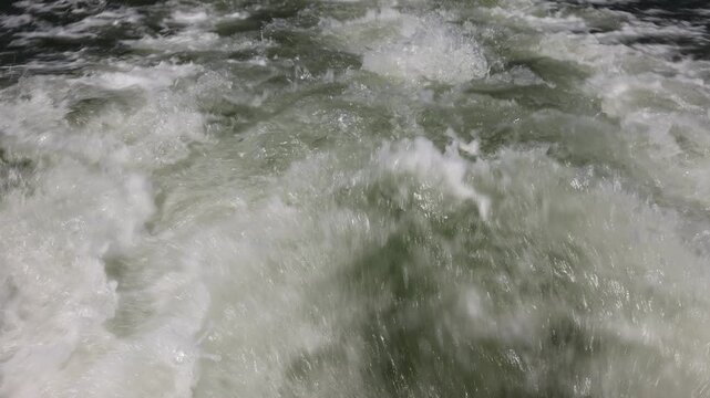 Waves and Wake Created by a Speedboat Moving Across the Sea