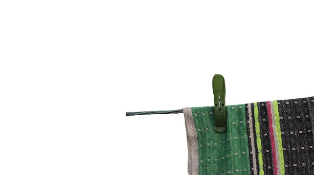Green clothespin on fabric isolated on a transparent background