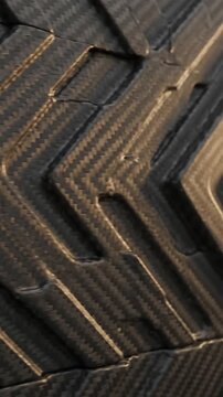 Carbon Fiber Texture with Diagonal Weave Pattern Shifting in Light. High-Resolution Close-Up Footage of Material Surface.