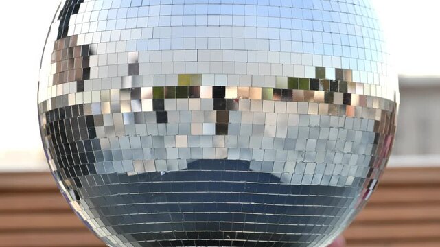 Disco ball hanging, reflecting light with shiny mirrors, creating a festive atmosphere
