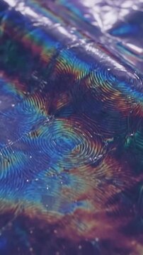 Iridescent Oil Slick Surface Flowing and Shifting with Vibrant Colors, Creating a Mesmerizing Abstract Motion Graphics Background.