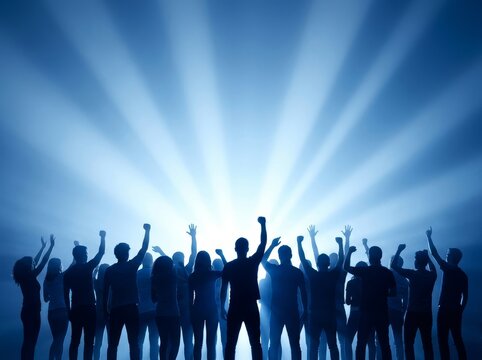 A group of people in silhouette raising arms against a bright light, symbolizing unity.
