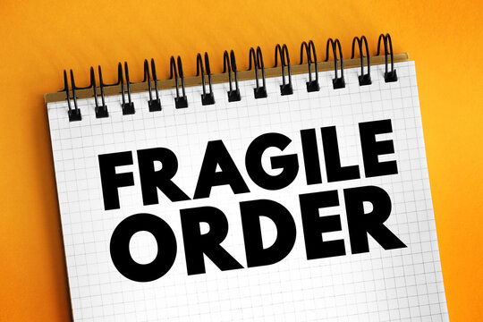FRAGILE ORDER concept text on a spiral notepad sheet, symbolizing delicate global stability, political vulnerability, security risks, system crisis management, and international diplomacy.