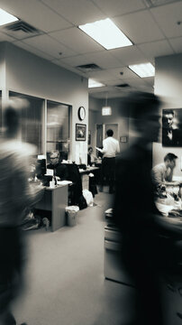 Blurred employees moving through a busy modern office