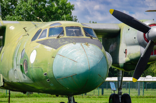 Vintage trainer aircraft parked in a row during an outdoor aviation exhibition.  Historical military planes on public display at an open air aviation museum. Old aircraft collection plane in daylight