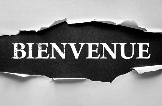 Torn paper effect revealing the French word BIENVENUE, meaning welcome, in bold distressed font. Concept of greeting, invitation, hospitality, arrival, and friendly atmosphere