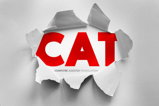 CAT Computer Assisted Translation text revealed through torn paper effect, language technology concept representing translation software, linguistic processing and productivity tools