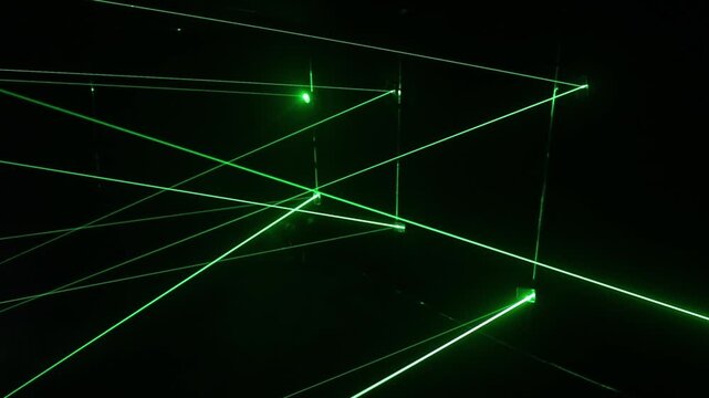 Green laser beams maze in dark room