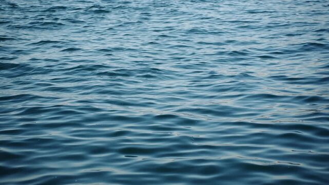 Blue sea water surface texture background, calm ocean waves with gentle ripples close up, liquid background for summer vacation and marine cruise travel concept, marine water texture.