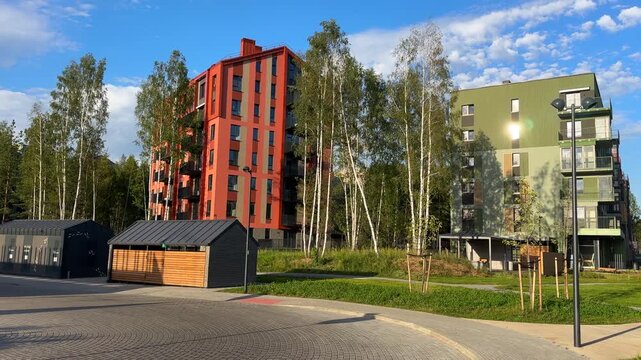 Neighborhood with new apartment complex. Facade of modern condominium in red and green colourful. Condo apartment building. Modern house block building. 