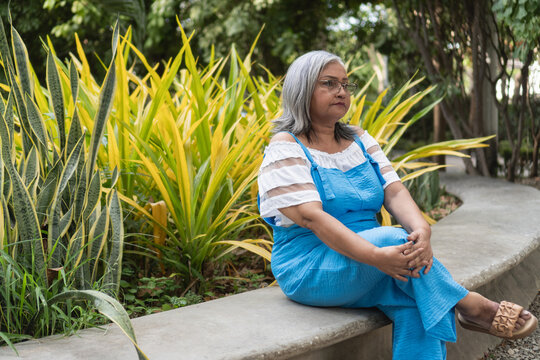 Senior woman relaxing outdoors in park environment