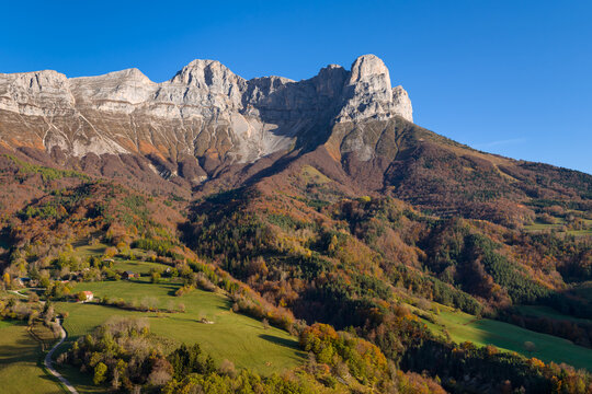 Aerial view of the Vercors Massif with La Grande Moucherolle mountain peak in autumn, featuring colorful forests in the Trieves region, Isere, France
