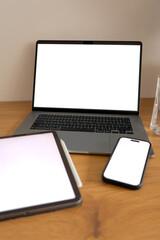 Connected device ecosystem showing laptop, tablet and smartphone with blank displays, symbolizing seamless access to digital content across platforms © Anna