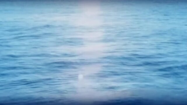 Blue Ocean Waves Sparkling with Sunlight Reflection