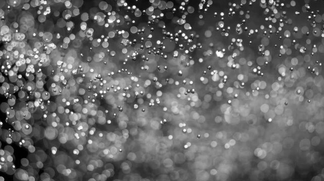 Floating abstract particle bokeh on dark background. Shot on super slow motion camera 1000 fps.