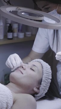 Gentle facial cleansing session under soft ring light