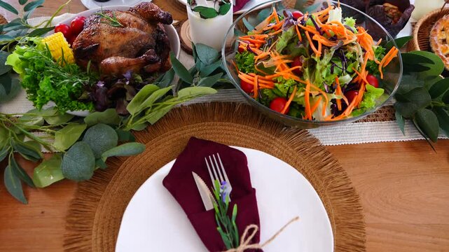 Dinnerware set including plates, spoons, knives, forks, napkins, placemats, dinner set for the dining room with roast chicken, dinner pie, party dinner in the dining room at home, family party. 