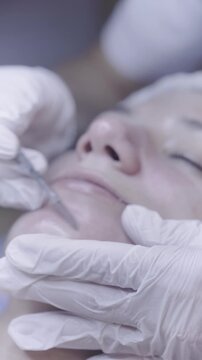 Careful hand movement near closed eye during calming facial care