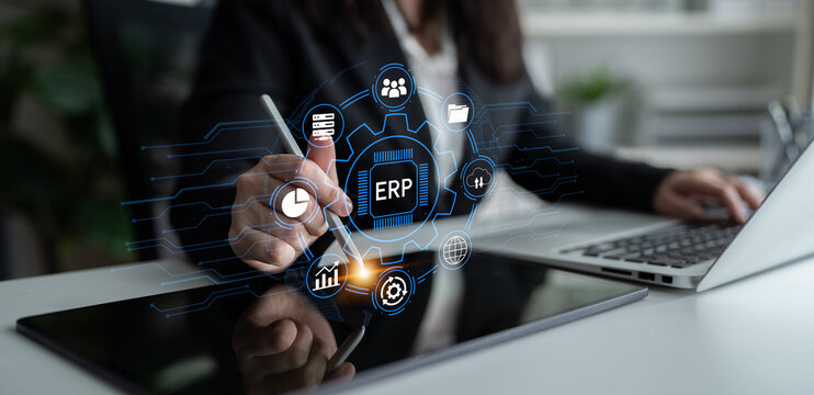 Modern Business Professional Engaging with Digital ERP System Interface while Working on Laptop in Contemporary Office Environment. Entropy.