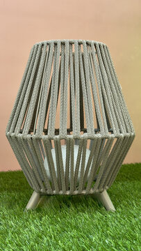 Modern woven outdoor floor lamp on artificial grass