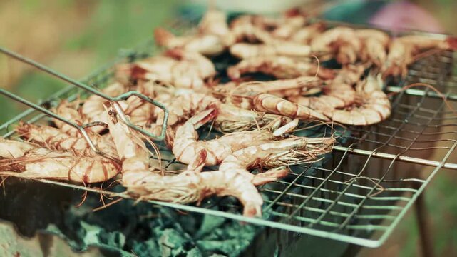 Flipping Grilling Shrimps On Metal Grate Barbecue Over Charcoals 