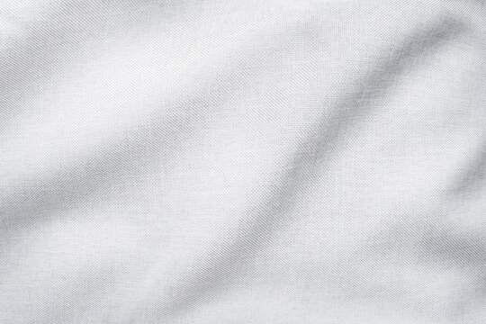 Wrinkled texture of white thick cotton fabric close-up