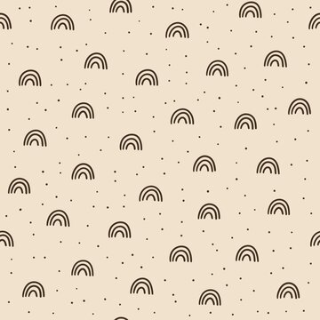 Seamless minimal pattern with hand drawn brown rainbows and small scattered dots on a warm beige background. Simple neutral boho design for kids textiles, nursery decor and wrapping paper.