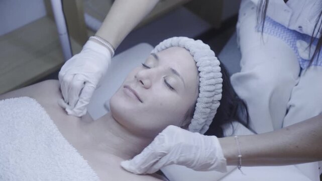 Serene facial massage performed with gentle gloved precision