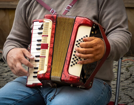 An Accordion on an mans lap