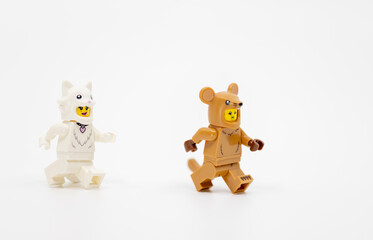 Fototapeta premium Hong Kong, June 8, 2026: Two minifigures wearing cat and mouse costumes run in a playful hunting chase.