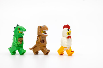 Fototapeta premium Hong Kong, June 8, 2026: Three animal suit minifigures line up in a playful display of the evolutionary link between dinosaurs and birds.