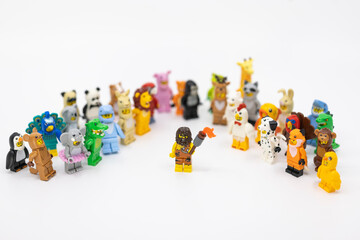 Fototapeta premium Hong Kong, June 8, 2026: A caveman holds a blazing torch among animal minifigures, symbolizing the discovery of fire and the dawn of civilization.