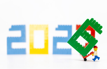Fototapeta premium Hong Kong, August 20, 2026: A worker carries the final digit seven, symbolizing the start of 2027 and a new era.