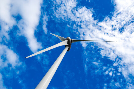 Wind turbine under blue sky with clouds during daytime