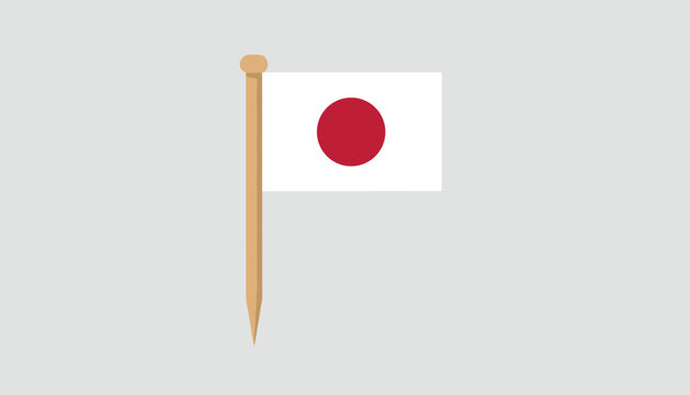 Toothpick flag of Japan with the red sun disk on a white background isolated over a plain grey backdrop.