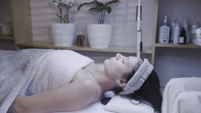 Skin care specialist prepares serum before gentle facial massage