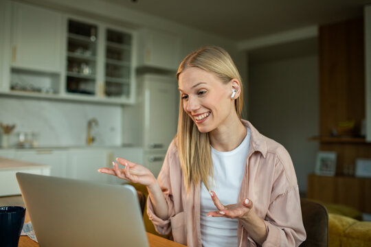 Smiling woman on video call in home kitchen