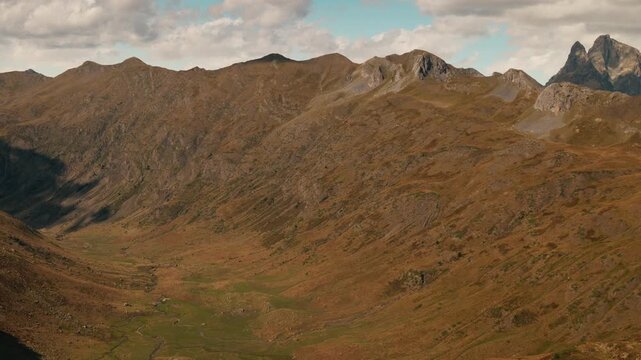 Sierra de Partacua brown slopes and green meadows in Huesca, Spain