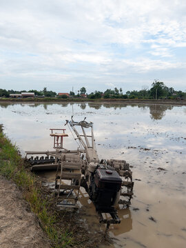 Agricultural Tiller Working in a Wet Rice Field