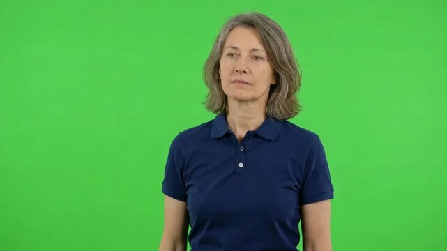 Woman in a blue polo shirt performing relaxed neck movements against a green background