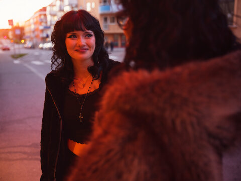Smiling fashionable woman with her girlfriend in city