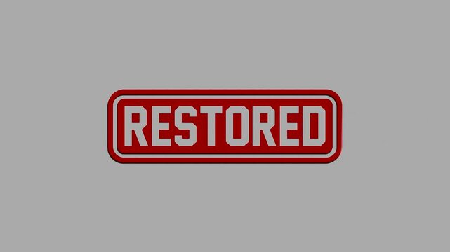 A shiny red rectangular badge with white restored text isolated on a gray background