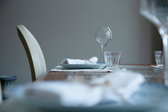 Two type of glasses kept near plate with napkin on dining table
