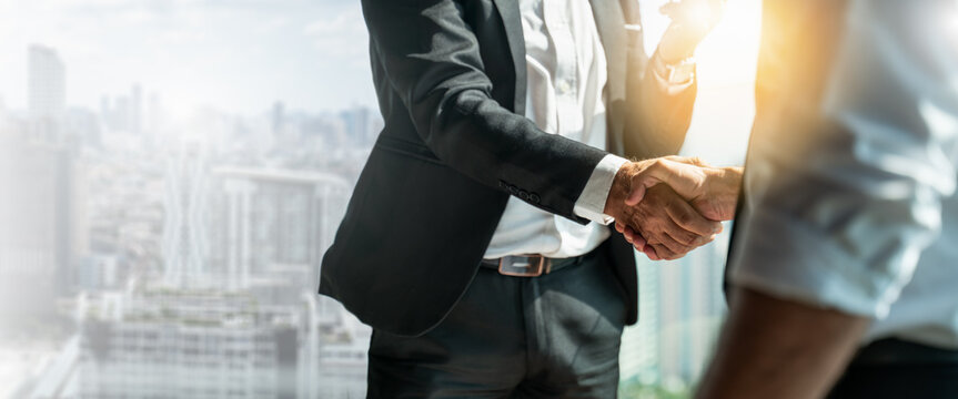 Businessman handshake for teamwork of business merger and acquisition,successful negotiate,hand shake,two businessman shake hand with partner to celebration partnership and business deal concept