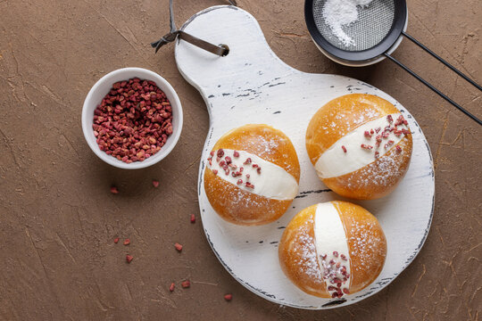 Maritozzo is a wonderful Italian dessert. Sweet and fresh whipped cream sandwiched between brioches.