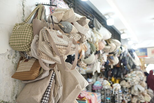 Tuesday, July 7, 2026, 12:23:42, jogja, indonesia _ Assortment of Woven and Fabric Handbags Displayed for Sale at a Traditional Street Market Stall