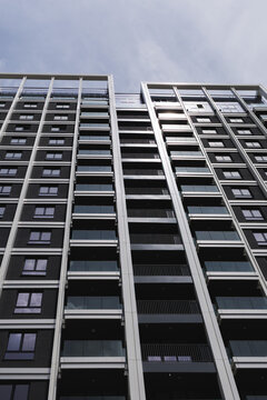 modern apartment building stands tall against the sky with many floors and windows