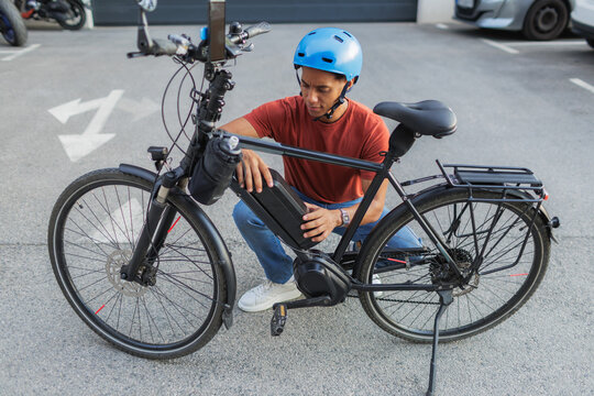 Man changing battery on his electric bicycle